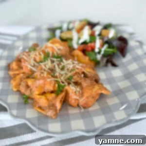 Easy Cheesy TikTok Tortellini 5 cheesy tortellini in a skillet with meat sauce