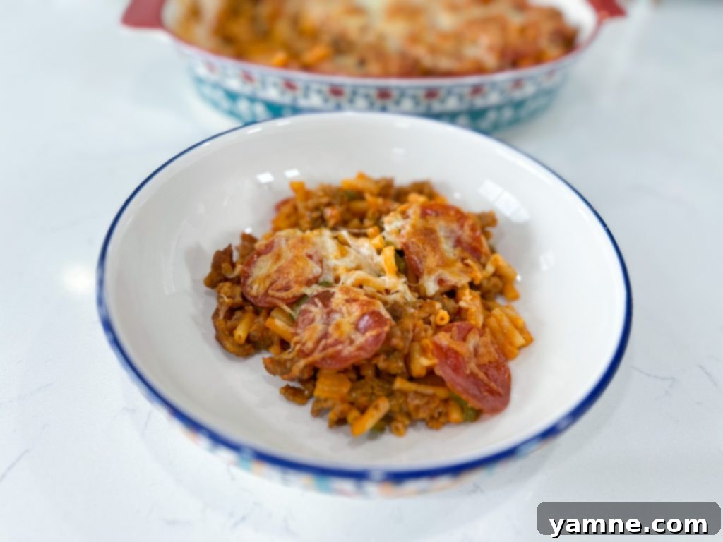 Top-down view of the freshly baked Macaroni and Cheese Pizza Casserole in a baking dish, ready to be served