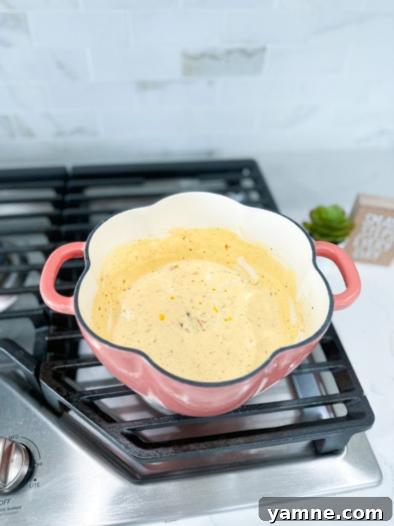 Cream, sun dried tomato, Parmesan, and remaining seasonings to a saucepan.