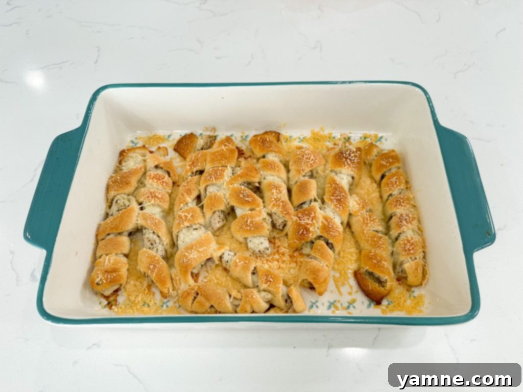 Golden baked chicken wrapped in crescent dough, drizzled with creamy sun-dried tomato sauce