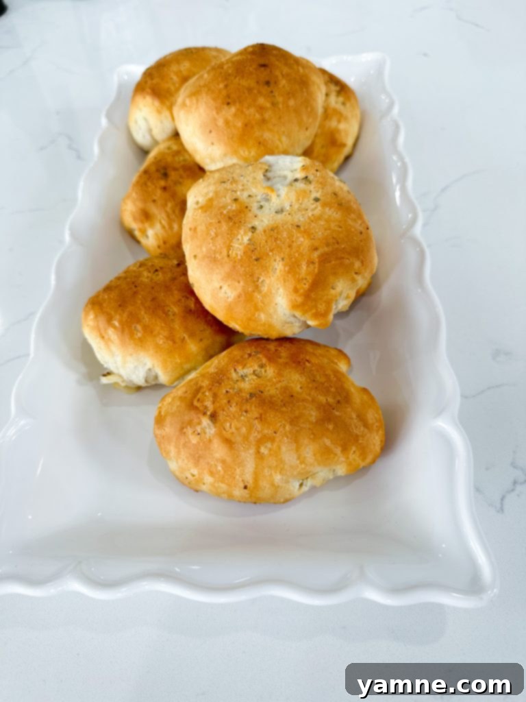 Stuffed Ham and Cheese Biscuits with deli ham and mozzarella ready for baking.