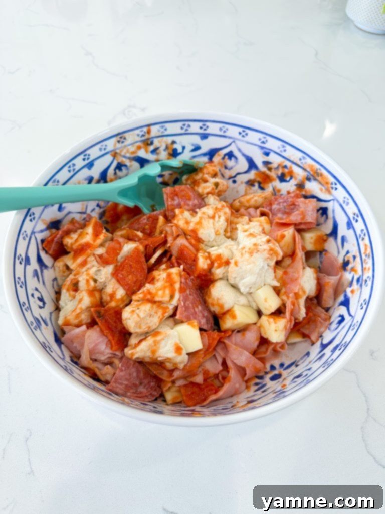 Diced refrigerated biscuits in a large mixing bowl, ready for other ingredients.