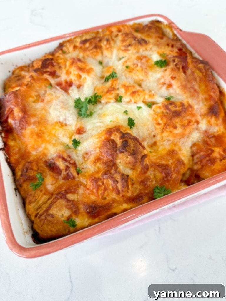 Unbaked Italian Sub Casserole in a dish, topped with cheese and covered with foil.