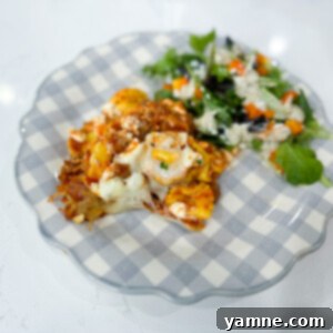 Effortless Slow Cooker Sausage Tortellini Lasagna 9 A serving of Slow Cooker Sausage Tortellini Lasagna in a bowl, showcasing the rich layers and melted cheese.