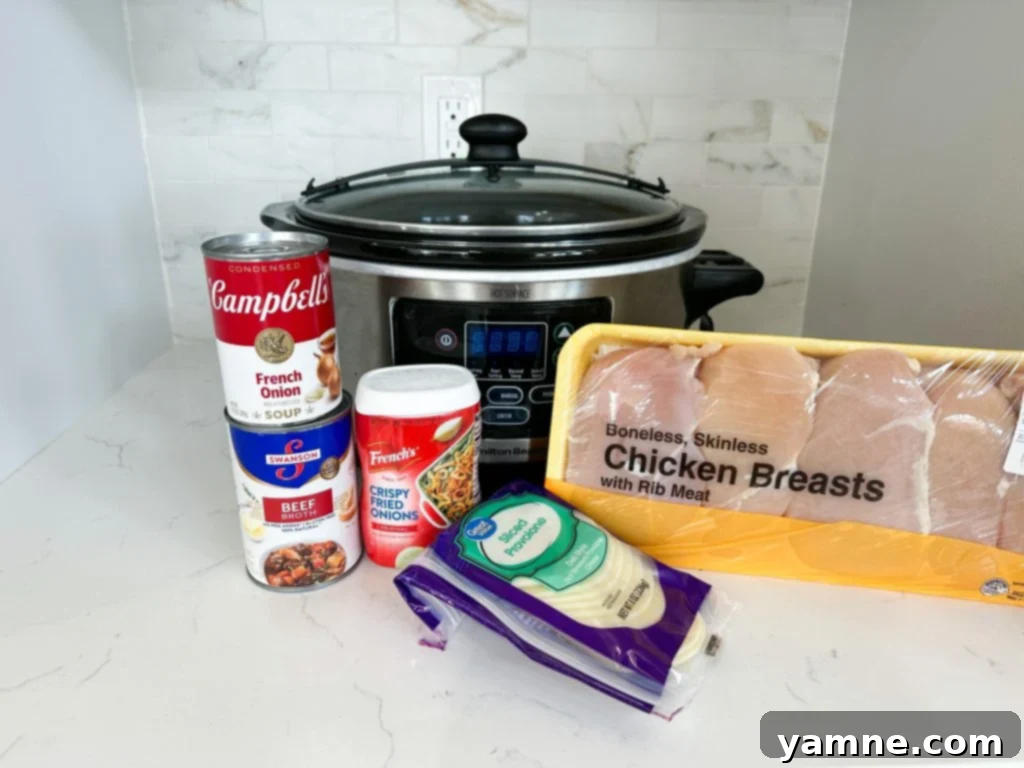 Delicious Slow Cooker French Onion Chicken with melted provolone cheese and crispy fried onions.