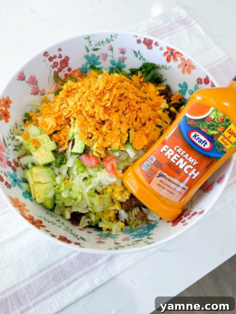 A serving of Doritos Taco Pasta Salad on a white plate, ready to be enjoyed.