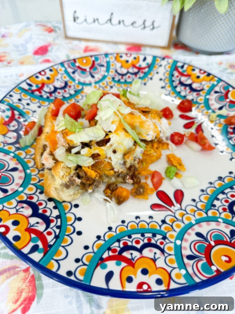 Doritos Taco Bake 11 Close-up of a sliced Dorito Taco Pie, showing layers of beef, sour cream, cheese, and Doritos