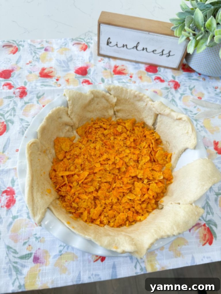 Doritos Taco Bake 4 Adding taco seasoning to cooked ground beef for taco pie