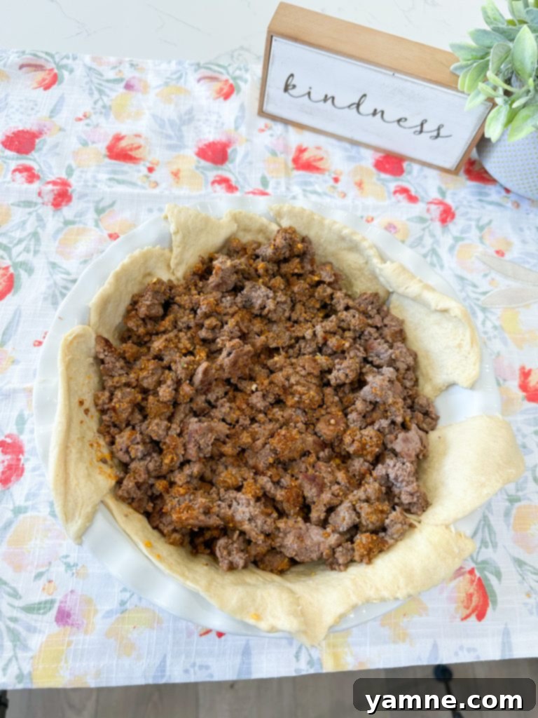 Doritos Taco Bake 5 Crescent dough unrolled in a pie dish, ready for filling