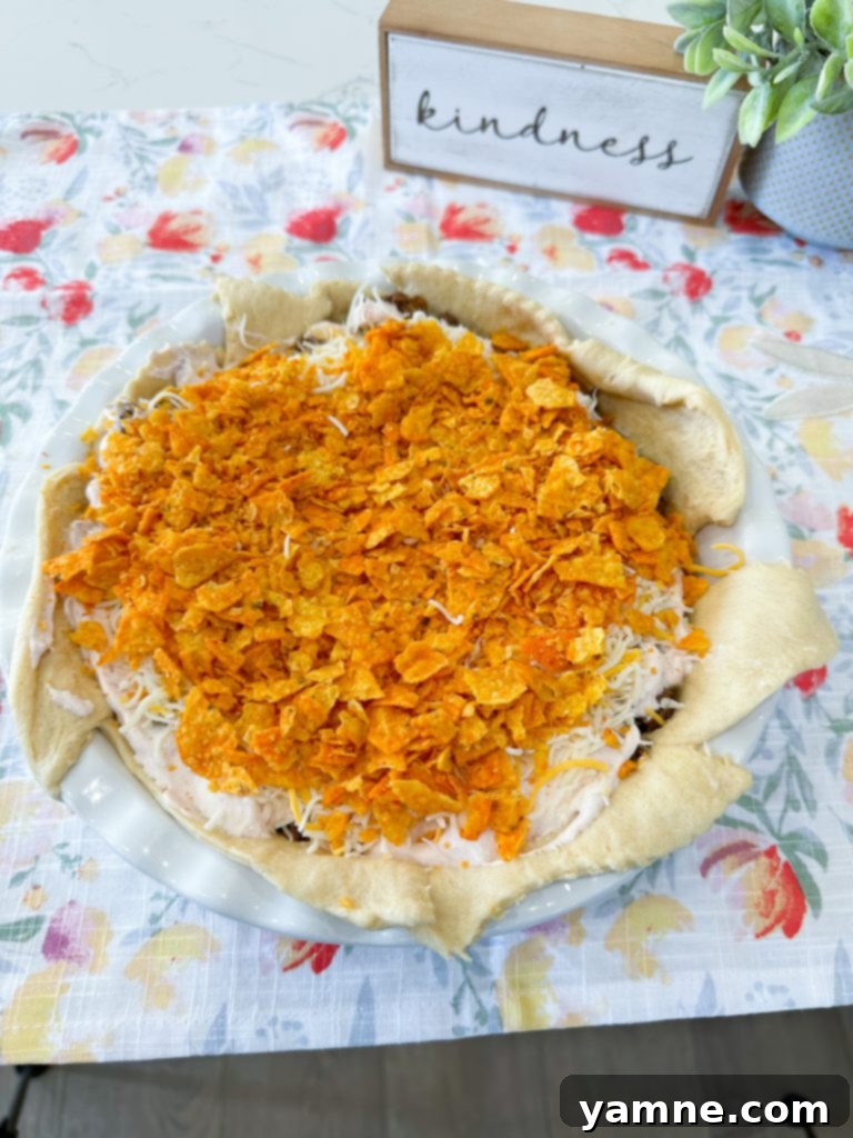 Doritos Taco Bake 8 Sour cream and salsa mixture spread over ground beef in taco pie