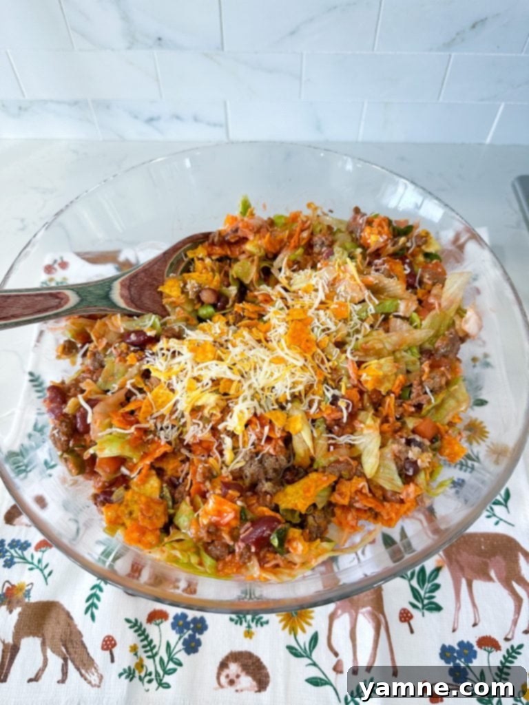 Crunchy Doritos Taco Salad 2 Delicious taco salad with Catalina dressing and crushed Doritos, served in a bowl.