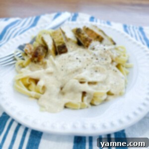 Velvety Chicken Fettuccine Alfredo 1 Delicious Classic Chicken Fettuccine Alfredo with creamy sauce, garnished with parsley