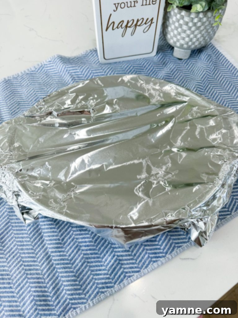 Evenly spreading the casserole mixture in the baking dish.