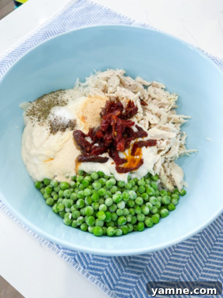Seasoning the casserole mixture with Italian seasoning and other spices.