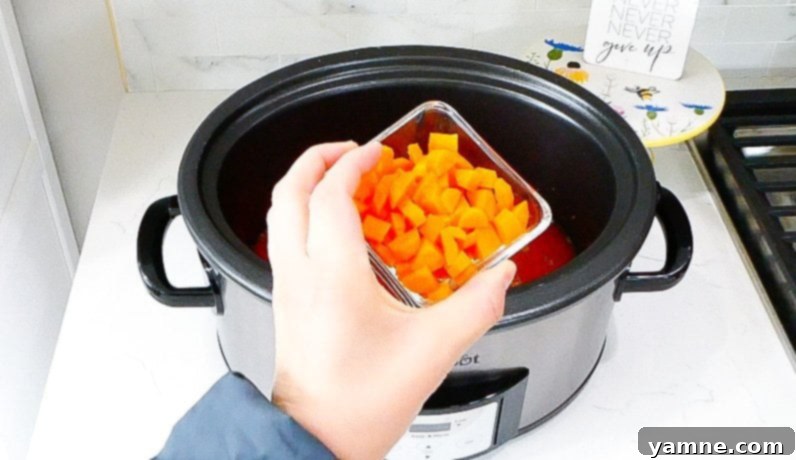 Fall-Apart Slow Cooker Beef Ragu 6 Ingredients being added to slow cooker