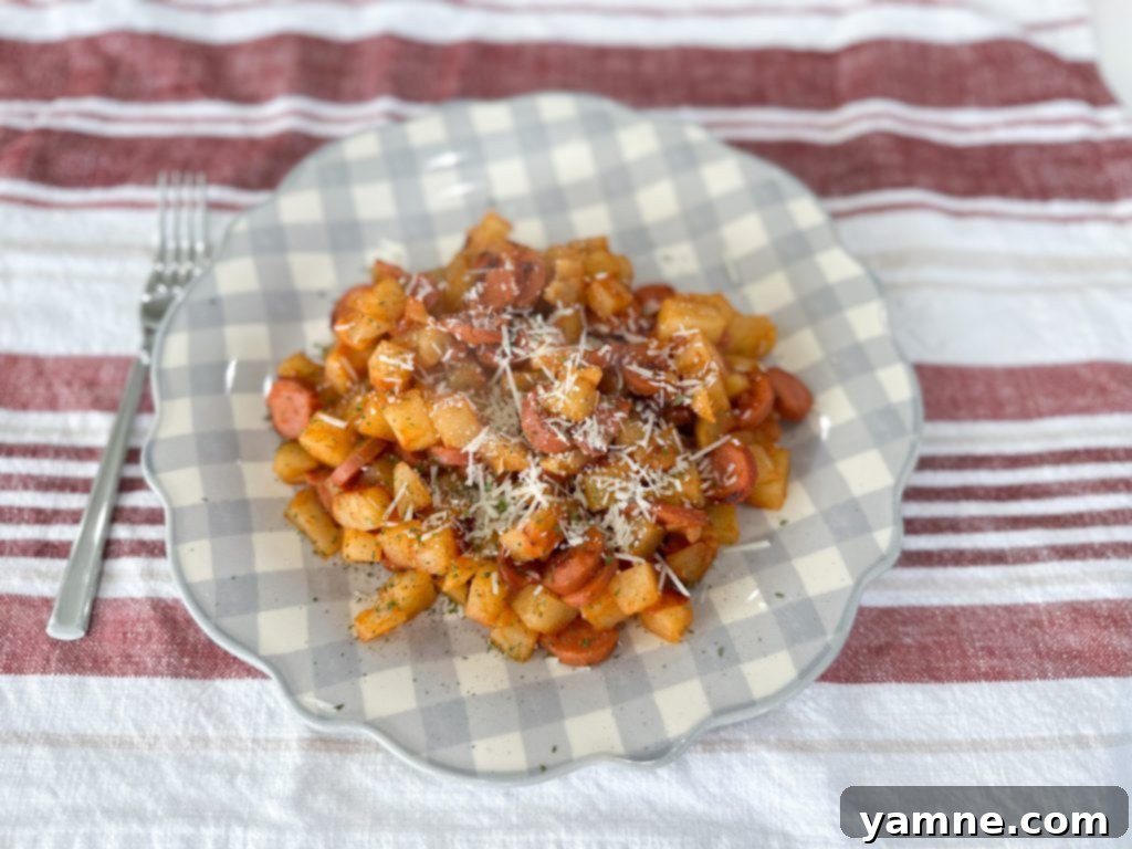 Shoestring Survival Meals 6 Close-up of baked Potato Sausage Casserole with a spatula