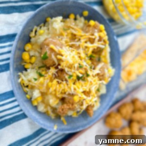Copycat KFC Famous Bowl with layers of mashed potatoes, chicken, corn, gravy, and cheese
