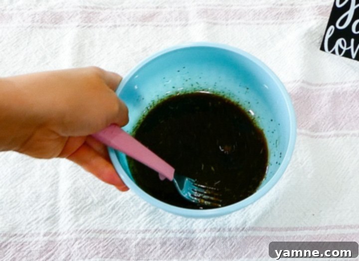 Close-up of fresh mozzarella pearls and cherry tomatoes, ready to be added to the pasta salad.