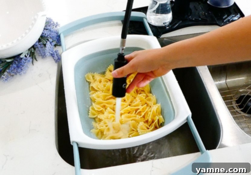 Cooled pasta transferred to a large mixing bowl.