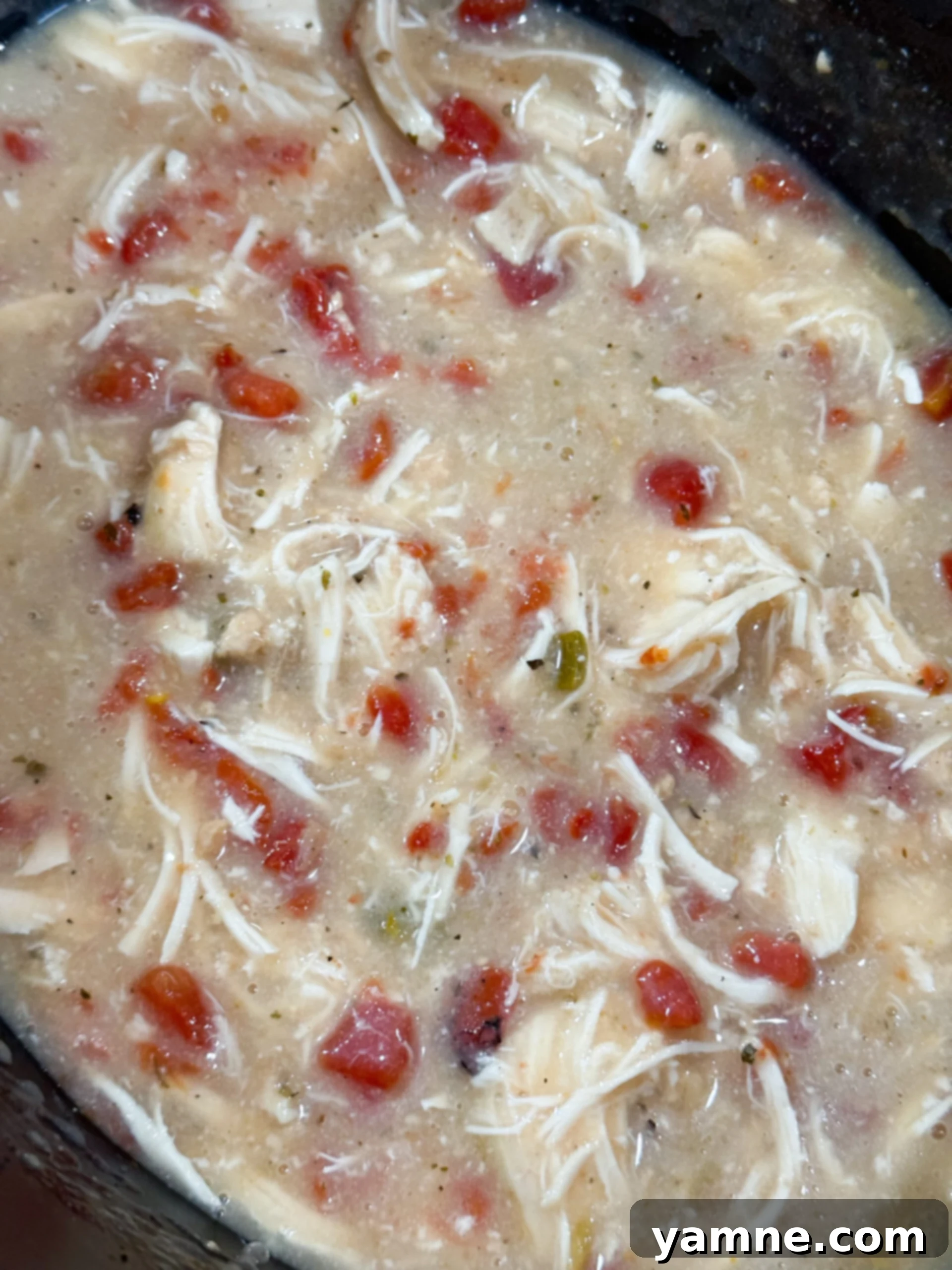 Easy Slow Cooker Creamy Rotel Chicken Pasta 7 Shredding cooked chicken in creamy sauce in slow cooker