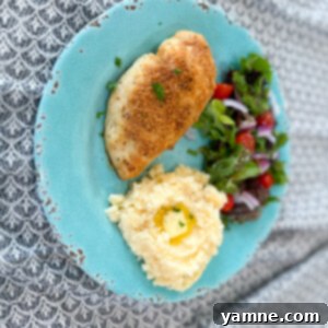 Golden brown, crispy Italian Parmesan Chicken garnished with fresh parsley