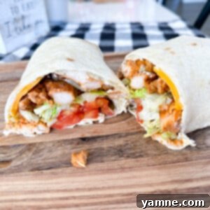 Pesto Chicken Wraps 2 Pesto Chicken Wraps with creamy pesto sauce, chicken, tomato, lettuce, and cheese.