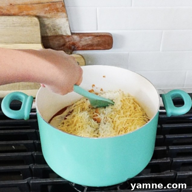 Tomato and Alfredo sauce simmering in a pot for creamy pasta
