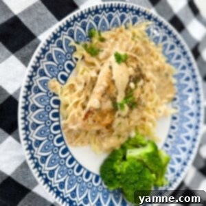 Golden brown chicken breasts coated in a rich, creamy garlic parmesan sauce, garnished with fresh parsley.