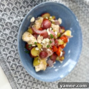 One-Pan Greek Chicken and Vegetables 2 Delicious Sheet Pan Greek Chicken and Vegetables, garnished with fresh herbs