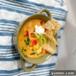 Delicious Creamy Tortilla Soup with shredded chicken and toppings