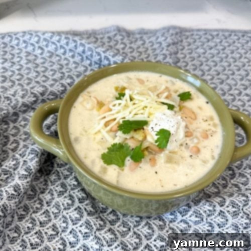 Creamy Slow Cooker White Chicken Chili in a bowl with toppings
