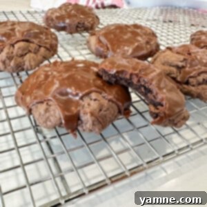 Fudgy Texas Sheet Cake Cookies with shiny chocolate glaze on a cooling rack