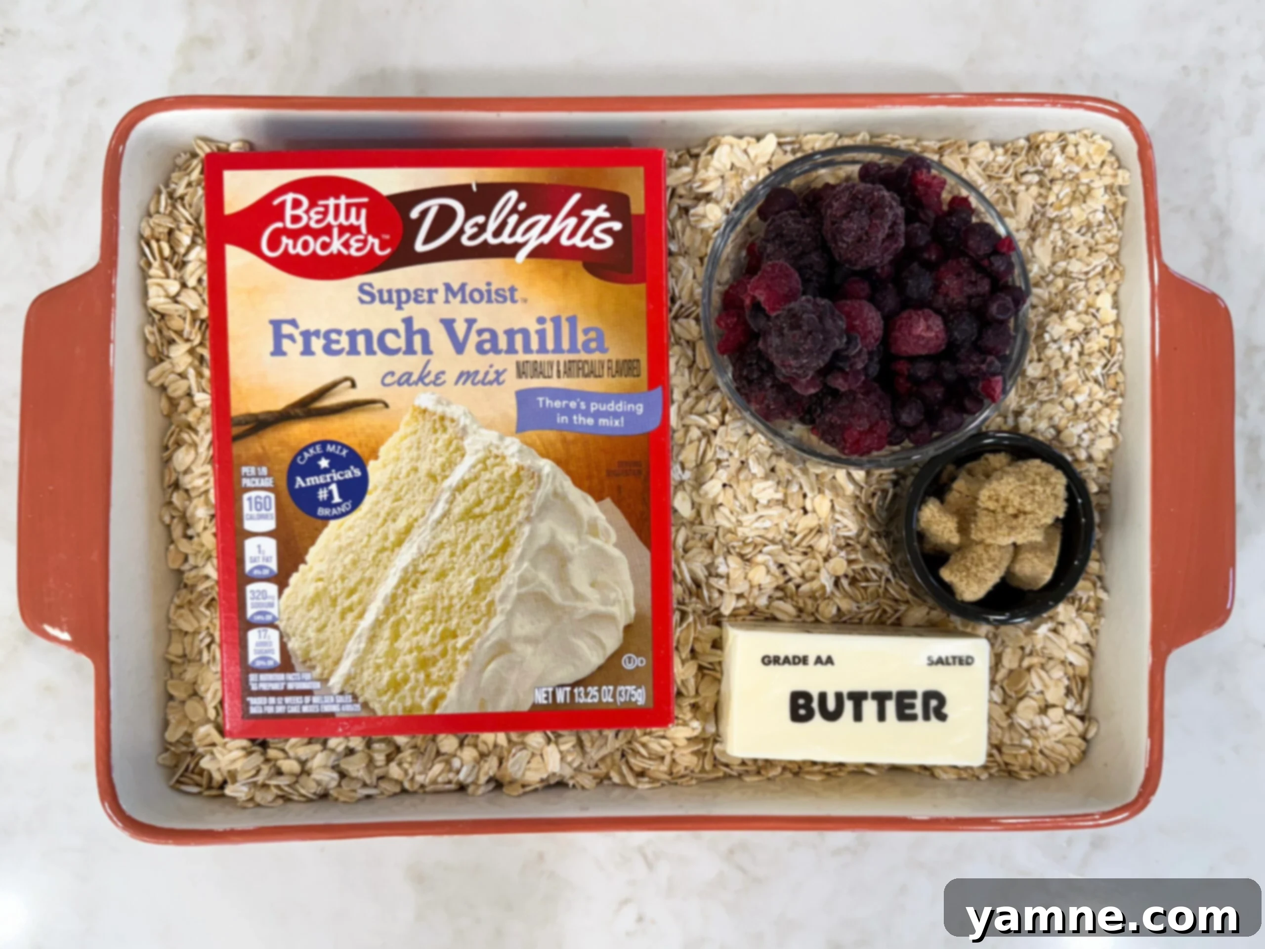 Ingredients for berry cobbler in casserole dish