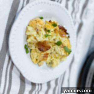 Delicious Slow Cooker Bacon Egg Casserole topped with melted cheese and fresh herbs, ready for breakfast or brunch