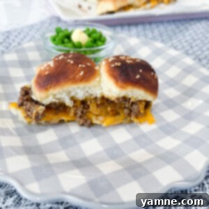 Close-up of golden brown hamburger sliders topped with sesame seeds