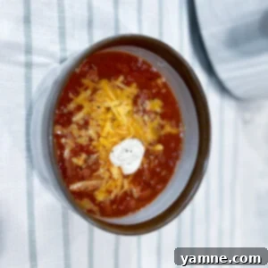 Turkey Chili 2 Delicious and hearty slow cooker ground turkey chili in a bowl, garnished with fresh cilantro.