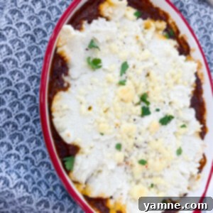 Spicy Mashed Potato Bake 2 Chili Mashed Potato Bake, a comforting casserole with layers of chili and creamy potatoes, topped with cheese.