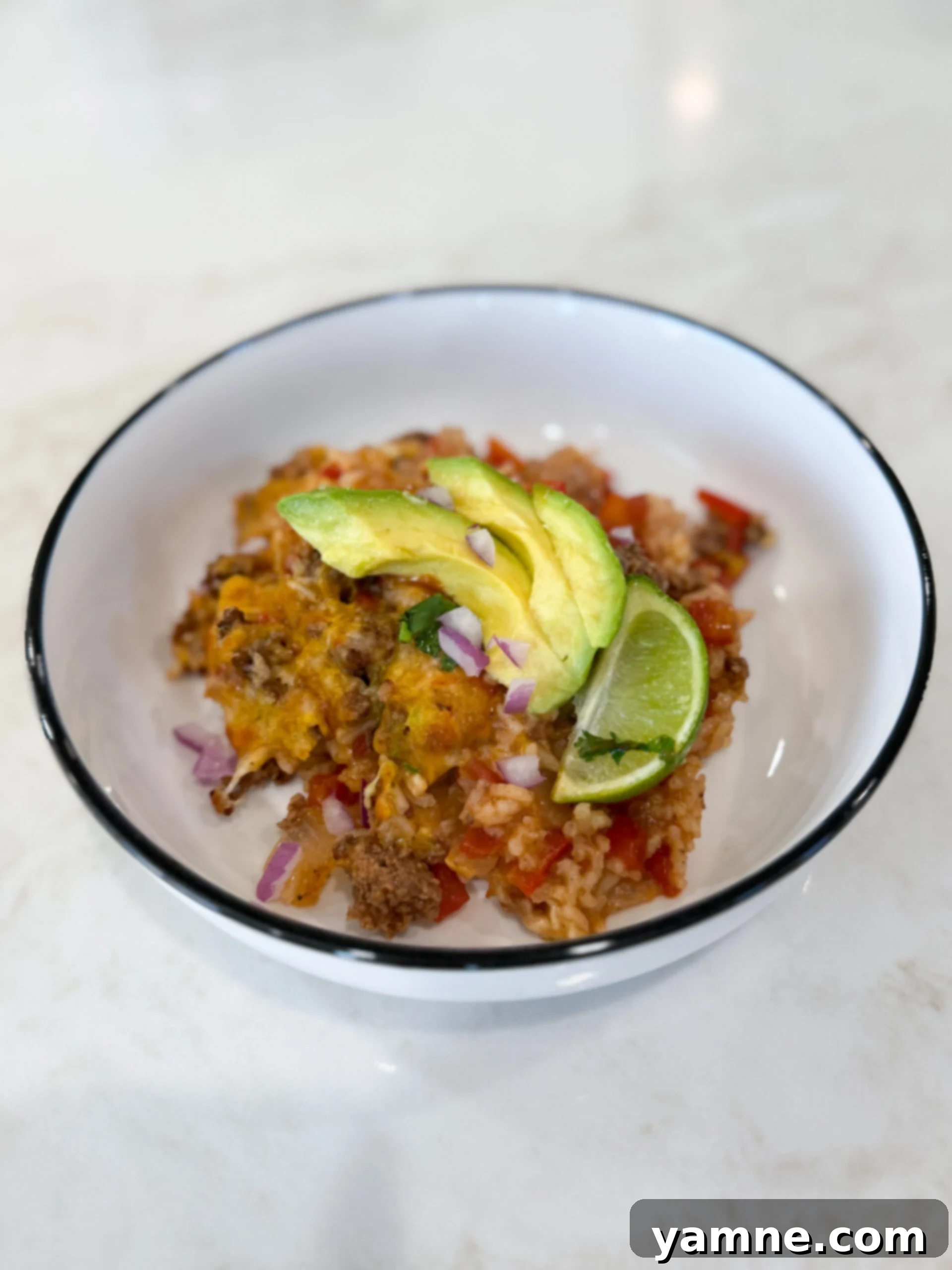 Cheesy stuffed pepper casserole baked in a bowl, golden brown and bubbly