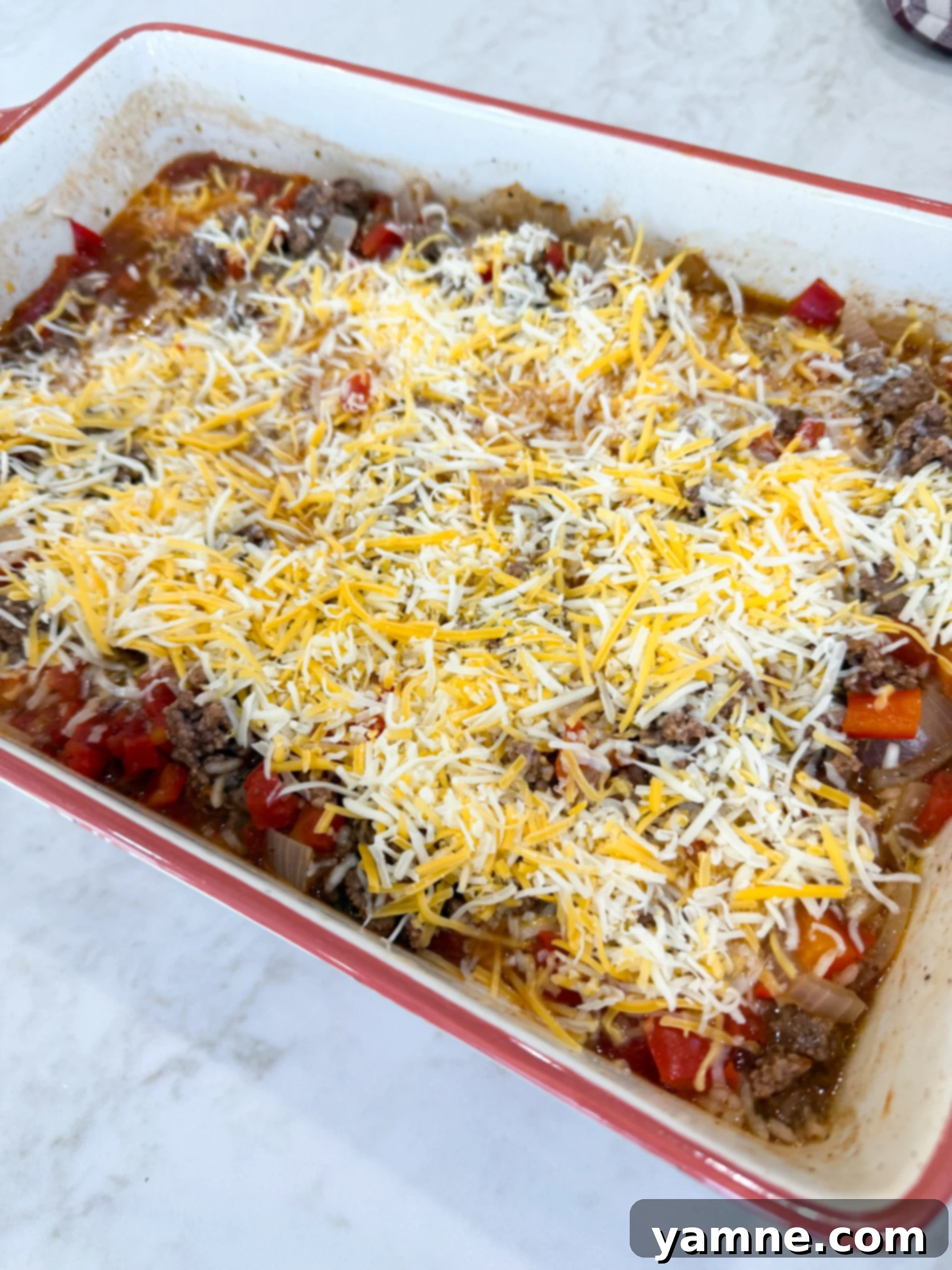 Melted cheese topping a freshly baked stuffed pepper casserole, golden and bubbly