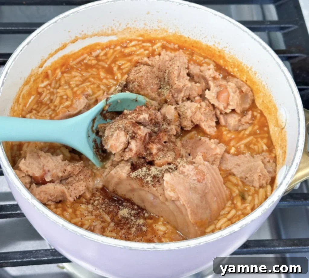 Mixing beans and rice for enchiladas