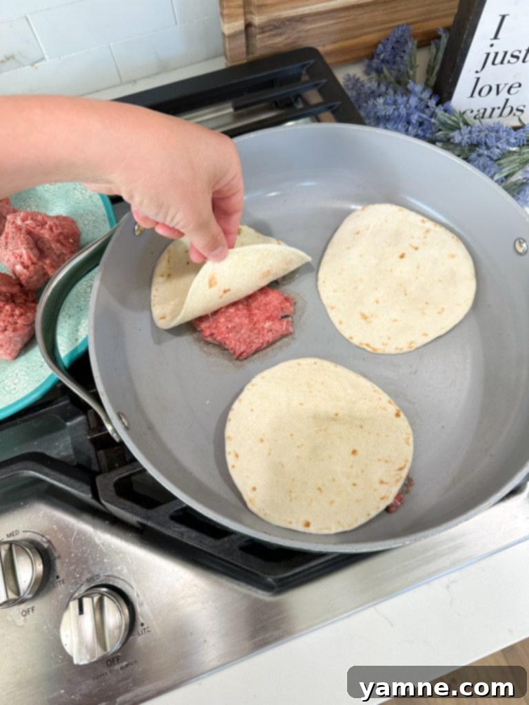 Cheeseburger Tacos 5 Smashing ground beef onto tortillas for easy hamburger tacos