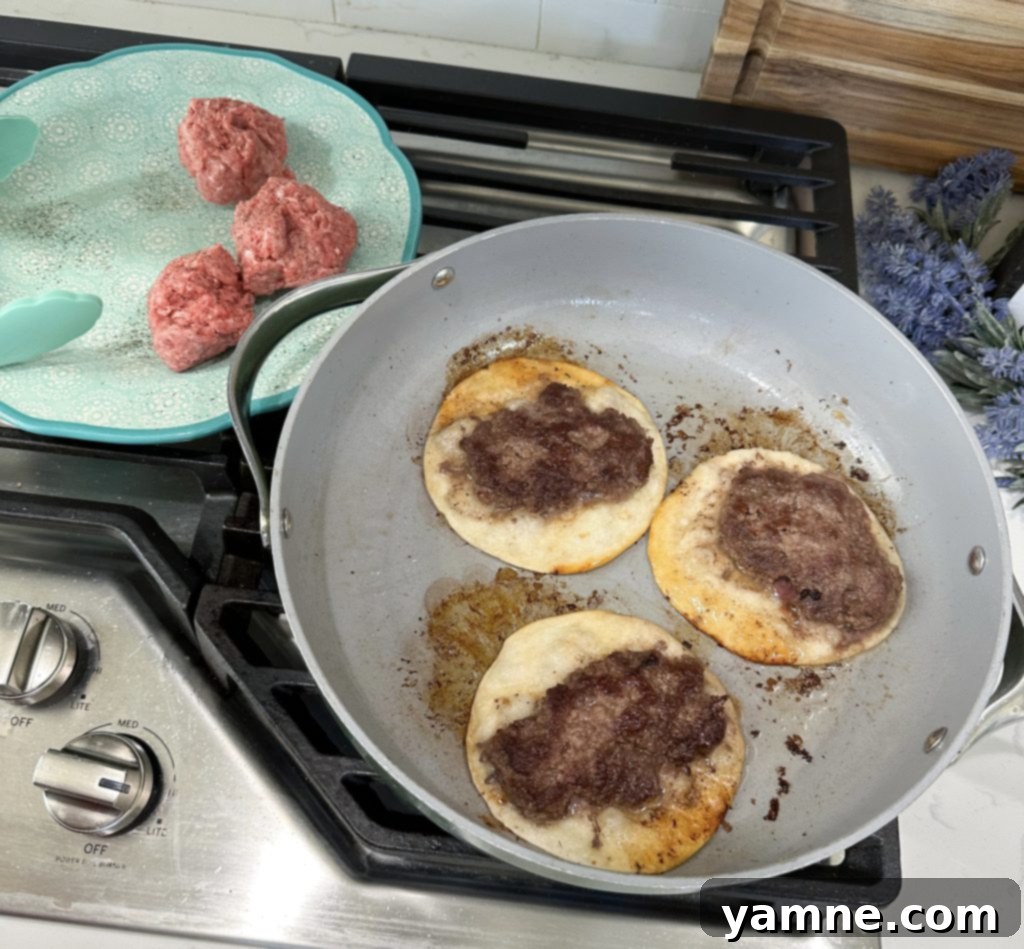 Cheeseburger Tacos 6 Cooked hamburger tacos on a griddle