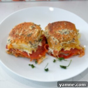 Delicious and easy pizza sliders, perfect for game day or a quick dinner, shown with melted cheese and golden buns.