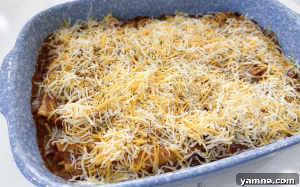 Taquito casserole baking in the oven before cheese is added