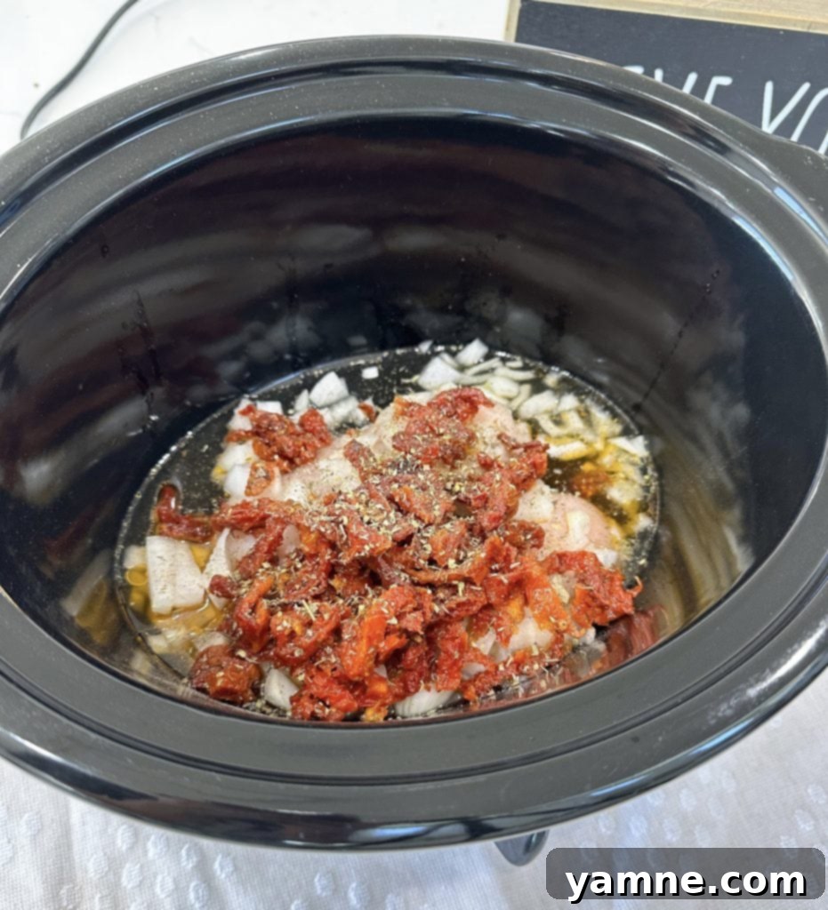 slow cooker chicken and orzo being prepared