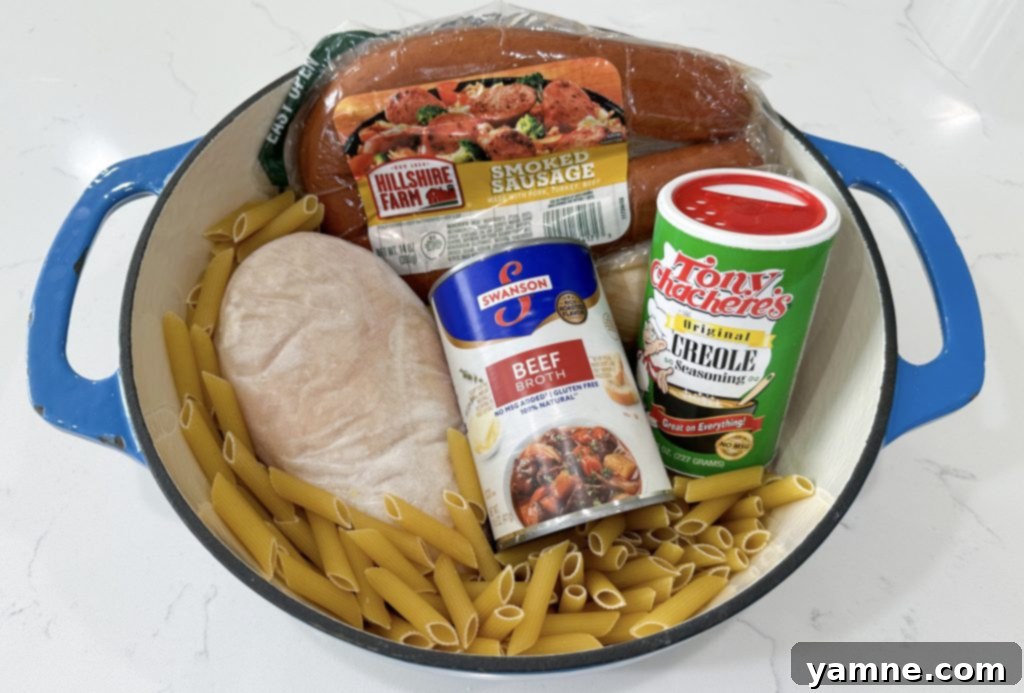Ingredients for one-pot cajun chicken alfredo on a cutting board