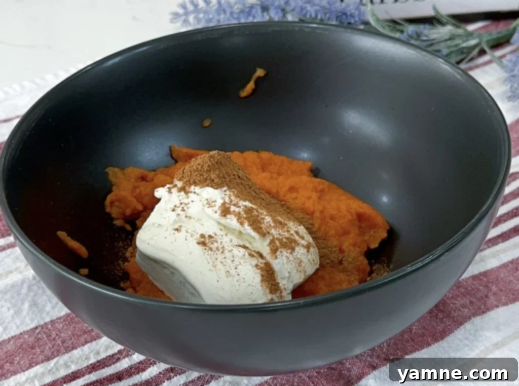 Swirled Pumpkin Cheesecake Brownies 4 Brownie batter being mixed in a bowl.