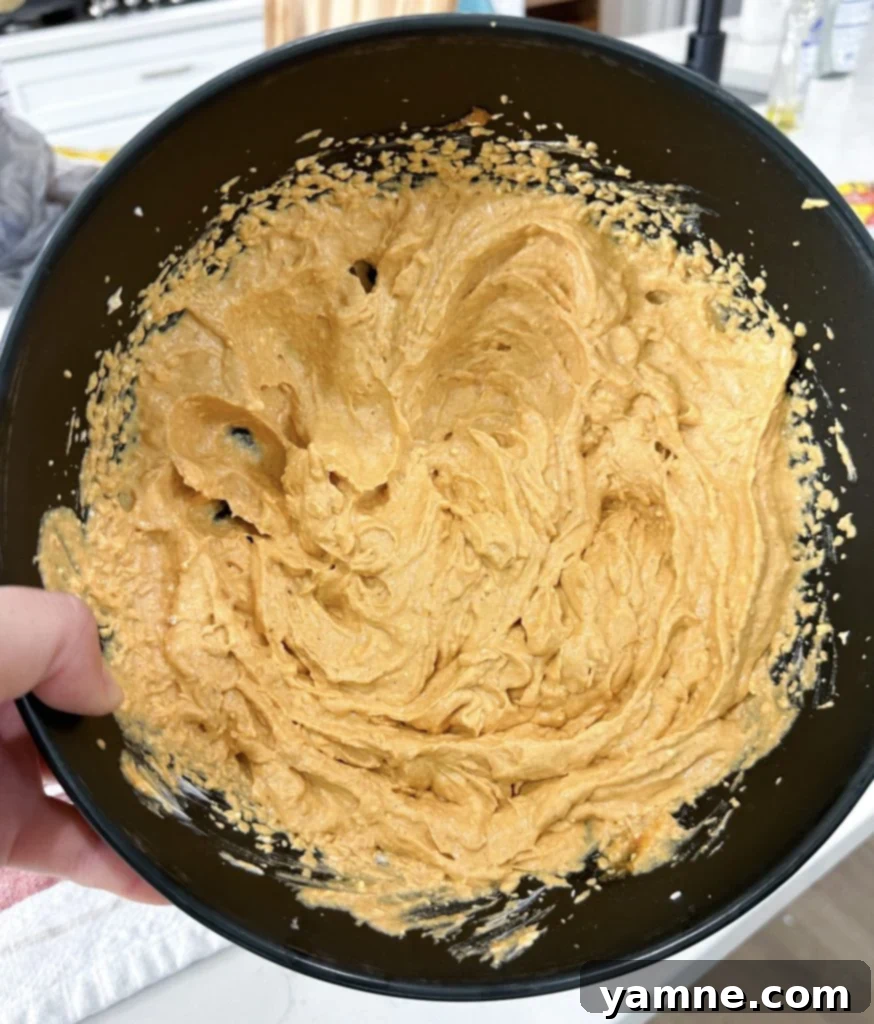 Swirled Pumpkin Cheesecake Brownies 5 Pumpkin cream cheese mixture being whisked until smooth.