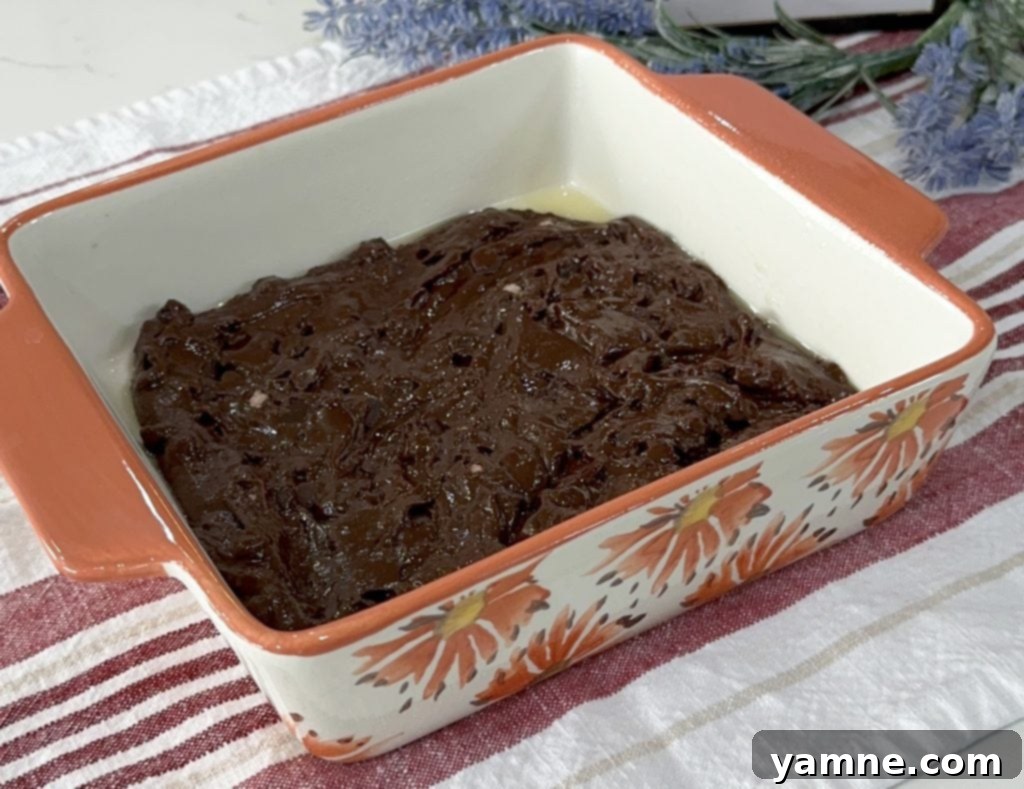 Swirled Pumpkin Cheesecake Brownies 6 First layer of brownie batter spread in the baking dish.