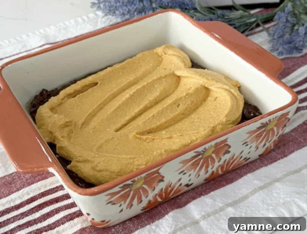 Swirled Pumpkin Cheesecake Brownies 7 Pumpkin cream cheese layer spread over the brownie batter.